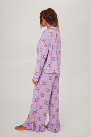 Texas Longhorn Lounger Game day pajamas featuring a girl wearing a purple set with Longhorn patterns.