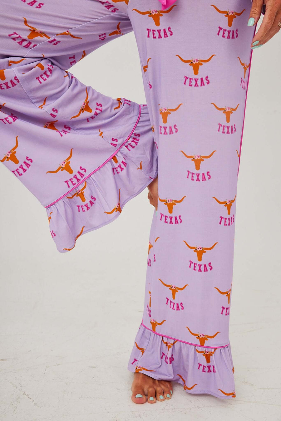 Texas Longhorn Lounger Game day pajamas featuring a playful purple design with Texas logos and a fun ruffle hem.
