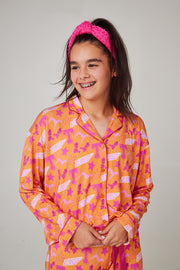 Girl wearing Tennessee Tranquility Time Gameday Pajamas with a pink headband, smiling and relaxed.
